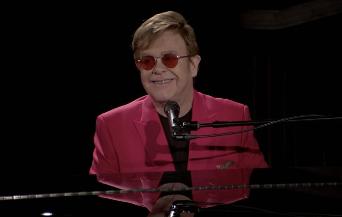 Elton John playing the piano