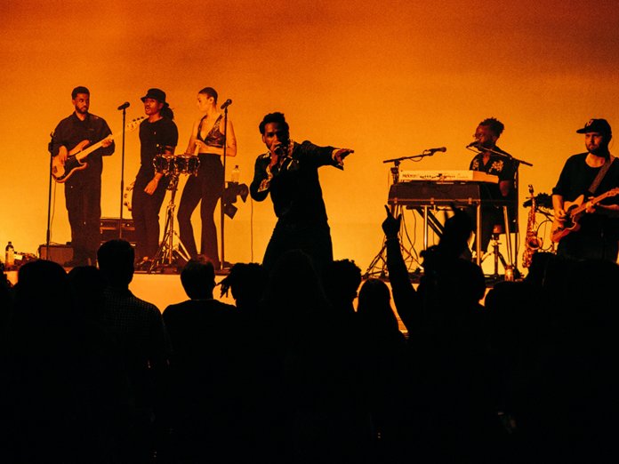 Leon Bridges performing live onstage with his band